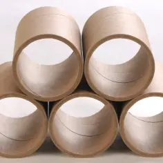 Pięć pustych tub z litej tektury ułożonych w piramidę.